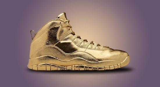 Close-up of Solid Gold OVO x Air Jordans sneakers.